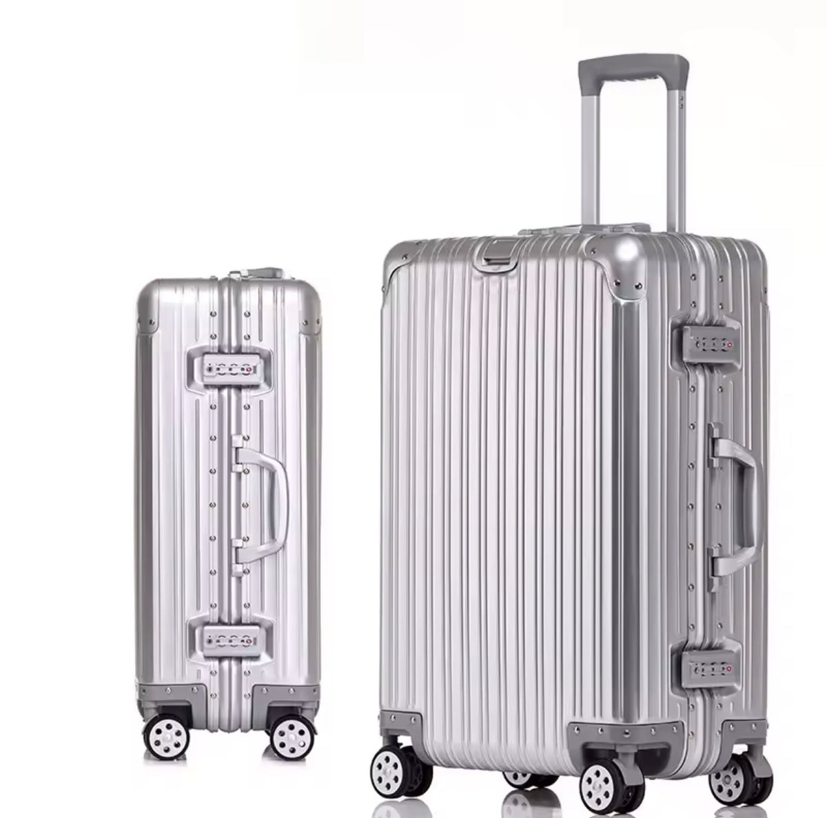 Two silver suitcases of different sizes on a white background