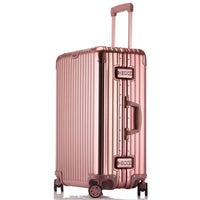 Rose gold suitcase with a reflective surface on a white background