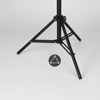 Black speaker stand with a blue triangle icon on a white background