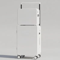 White stacked suitcases on a wooden floor with a neutral background