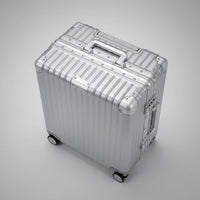 High-angle top view of The Aero-PC Vanguard — Carbon-Texture Frame Case in Palladium Silver. This image highlights the robust Aero-Aluminum zipperless frame, the integrated mechanical handle, and the riveted corner reinforcements that provide superior impact protection and structural rigidity for elite travelers.