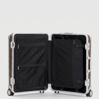 Interior view of Aeria Prestige The Monarch aluminum travel case in Damier brown, featuring dual packing compartments, zippered mesh divider pockets, and compression straps for organized travel.