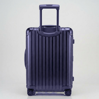 Rear view of The Masterpiece Legacy aluminum luggage by AERIA PRESTIGE in Abyssal Blue, showing the fully extended telescopic trolley handle, aerospace-grade alloy hardshell, and silent spinner wheels.