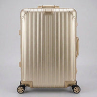 Front view of The Masterpiece Legacy aluminum luggage by AERIA PRESTIGE in Rose Champagne, featuring a premium zipperless aerospace-grade alloy hardshell and silent multi-directional spinner wheels.