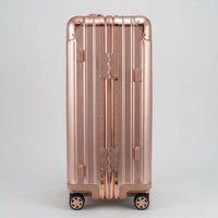 Side view of The Masterpiece Legacy aluminum luggage by AERIA PRESTIGE in Rose Gold, featuring a robust zipperless frame, reinforced hinges, and premium aerospace-grade alloy construction.