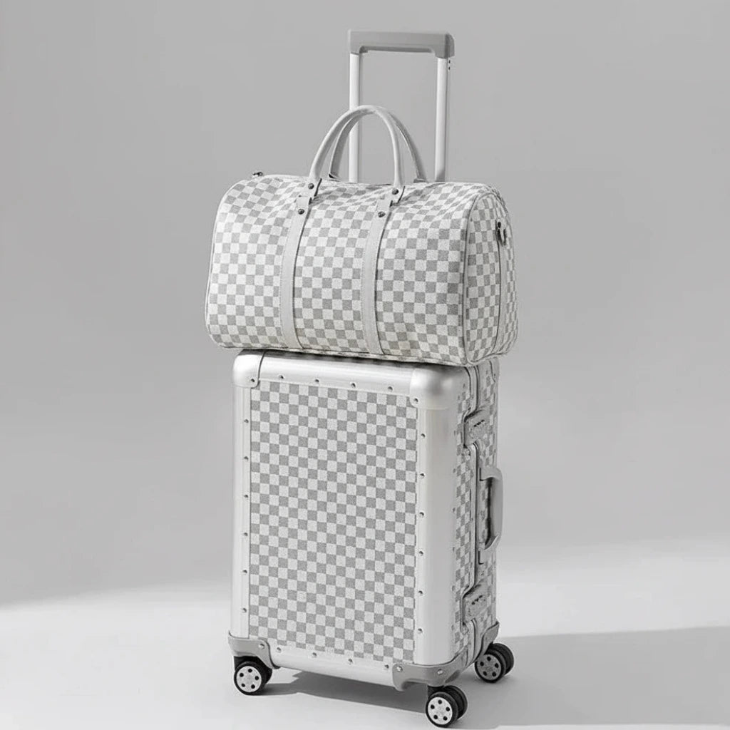 The Monarch 24-inch medium aluminum suitcase set in Arctic Silver, curated by AERIA Prestige with zipperless TSA locks and aerospace-grade alloy shell.