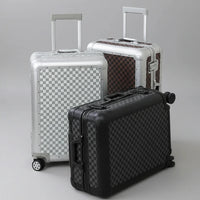 The Monarch premium aluminum carry-on collection in Midnight Onyx, Arctic Silver, and Heritage Bronze, curated by AERIA Prestige.