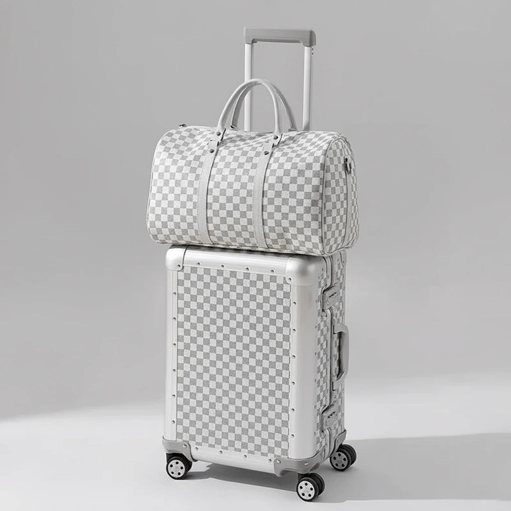 Checkered suitcase and duffel bag on a beige background