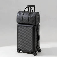 Black checkered suitcase with a matching duffel bag on a beige background