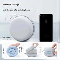 Portable storage device shown next to a smartphone, demonstrating its compact size.
