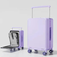 Purple suitcase with a smaller black suitcase inside on a light gray background