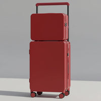 Two red suitcases stacked on a wooden floor with a neutral background
