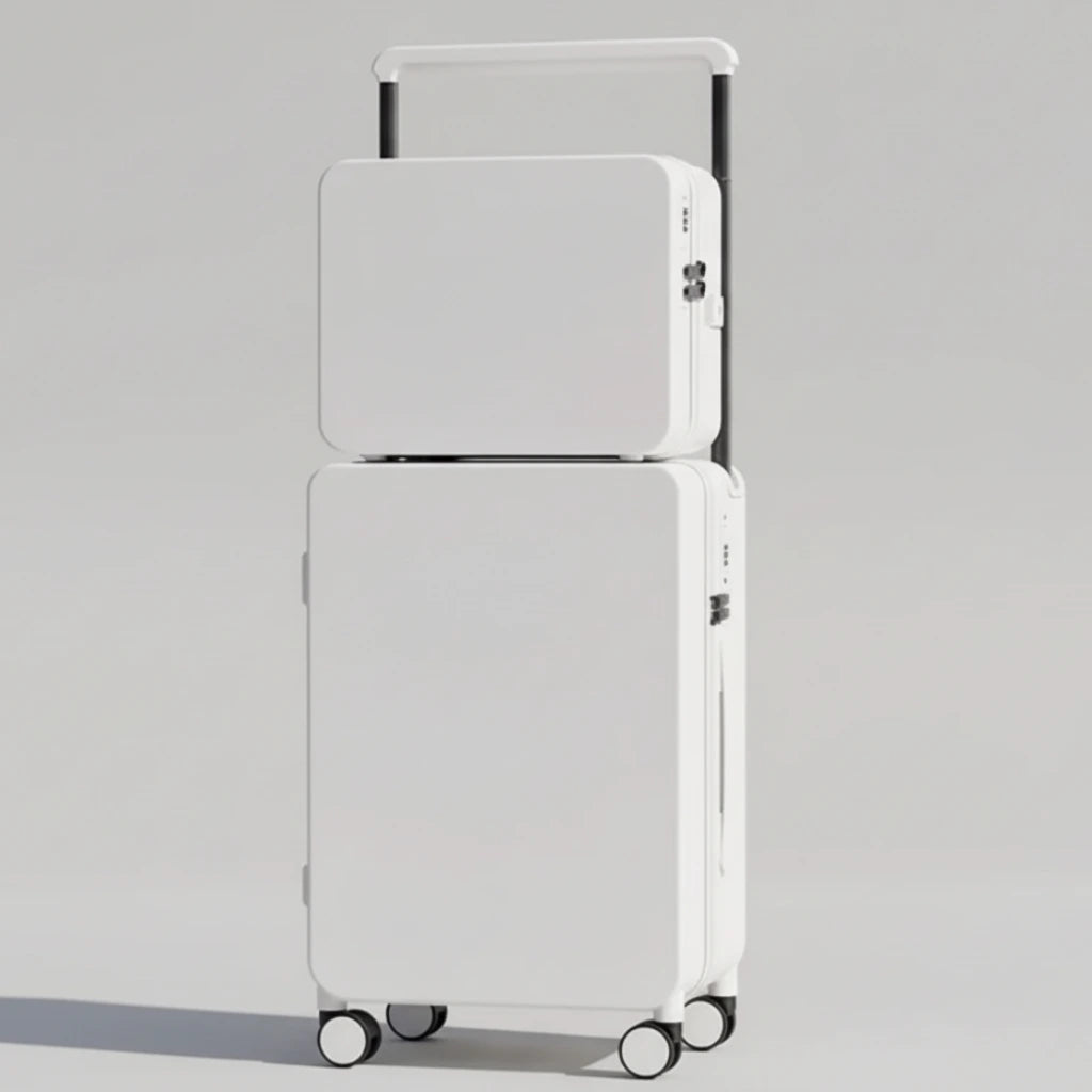 White stacked suitcases on a wooden floor with a neutral background