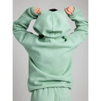 Light green hoodie with a plain background