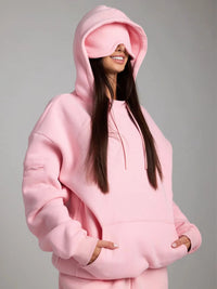 Person wearing a pink hoodie on a gray background