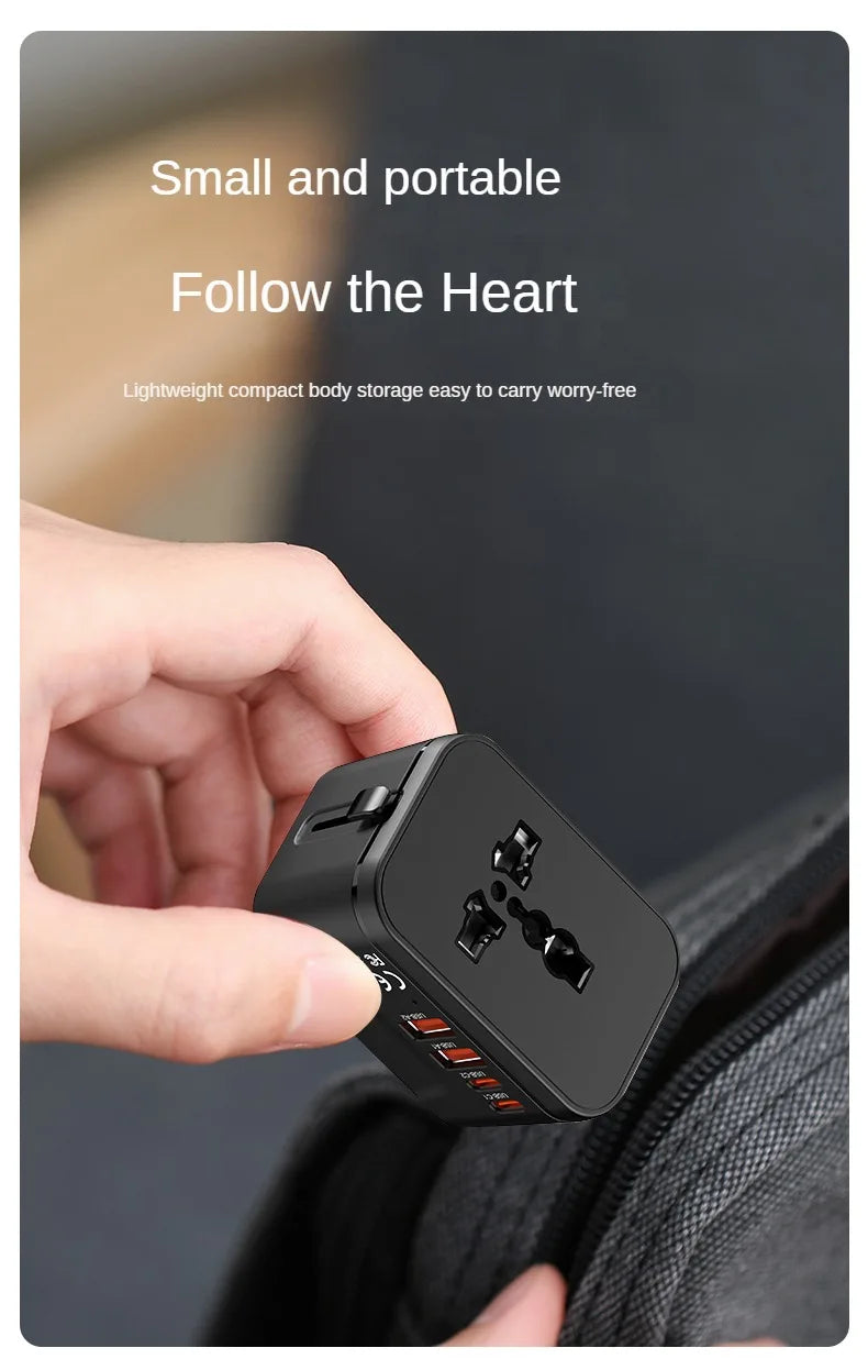 Hand holding a small travel adapter with text 'Small and portable Follow the Heart' on a blurred background.