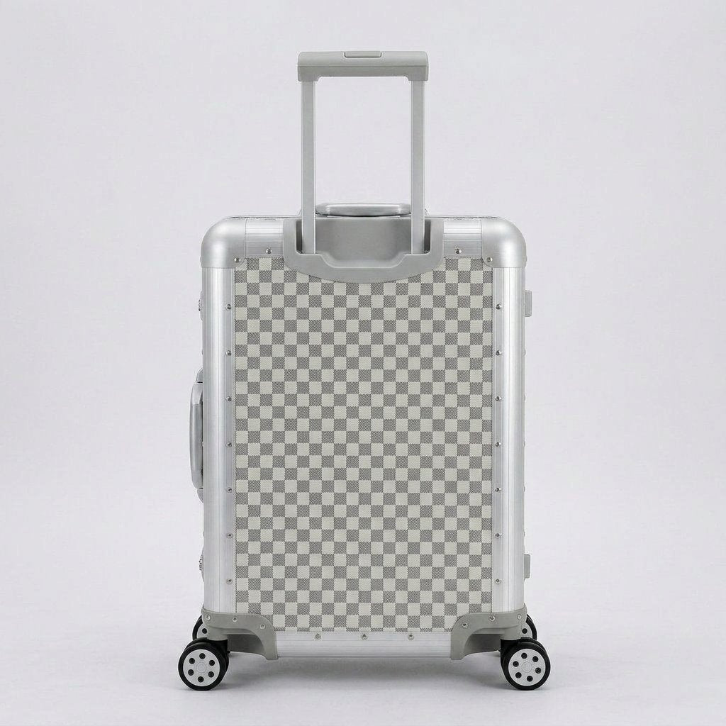 Rear view of Aeria Prestige The Monarch aluminum travel case in Alabaster White Damier checkered finish, displaying the retractable handle and smooth-rolling spinner wheels.