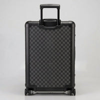 Rear view of Aeria Prestige The Monarch aluminum travel case in Matte Obsidian Damier checkered finish, displaying the retractable handle and smooth-rolling spinner wheels.