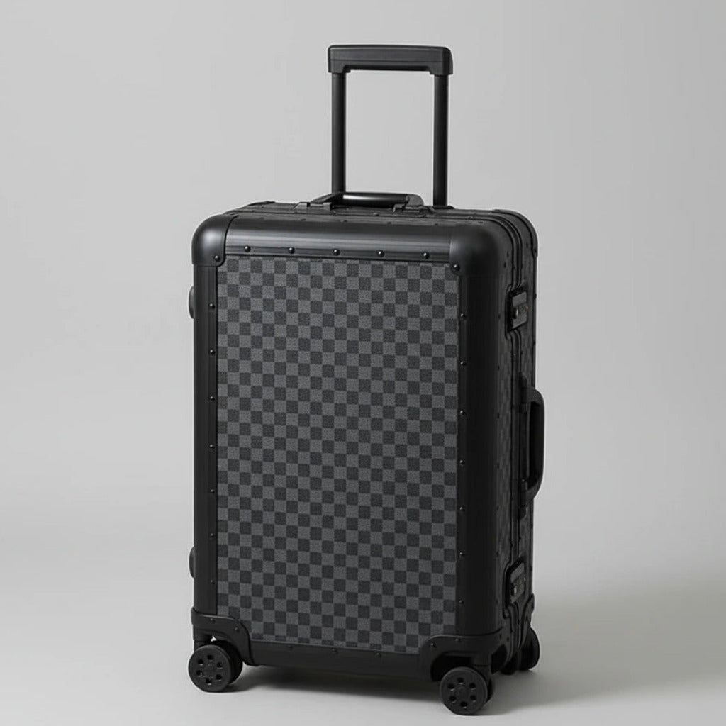 Aeria Prestige The Monarch aluminum travel case in Matte Obsidian Damier checkered finish, shown in a studio three-quarter view with extendable handle and smooth spinner wheels.