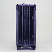 Side view of The Masterpiece Legacy aluminum luggage by AERIA PRESTIGE in Abyssal Blue, highlighting the heavy-duty zipperless frame, reinforced hinges, and durable aerospace-grade alloy construction.