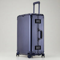 Full-length side view of The Masterpiece — The Legacy Aluminum Luggage in the Deep Azure finish. As part of the AERIA PRESTIGE Titan Series, this luxury travel case features an aerospace-grade aluminum-magnesium alloy chassis, silent multi-directional wheels, and integrated TSA-approved locks, offering a calm and professional aesthetic for elite travelers