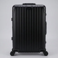 Front view of The Masterpiece Legacy aluminum luggage by AERIA PRESTIGE in Obsidian Black, featuring a premium zipperless aerospace-grade alloy hardshell and silent multi-directional spinner wheels.