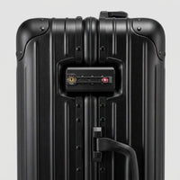 Close-up of the integrated dual TSA-approved combination locks on The Masterpiece Legacy aluminum luggage by AERIA PRESTIGE in Obsidian Black, featuring a bank-grade security design.