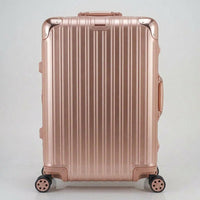Front view of The Masterpiece Legacy aluminum luggage by AERIA PRESTIGE in Rose Gold, featuring a premium zipperless aerospace-grade alloy hardshell and silent multi-directional spinner wheels.