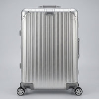 Front view of The Masterpiece Legacy aluminum luggage by AERIA PRESTIGE in Sterling Silver, featuring a premium zipperless aerospace-grade alloy hardshell and silent multi-directional spinner wheels.