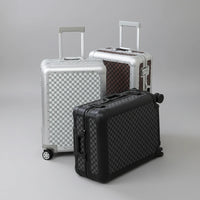 The Monarch premium aluminum carry-on collection in Midnight Onyx, Arctic Silver, and Heritage Bronze, curated by AERIA Prestige.